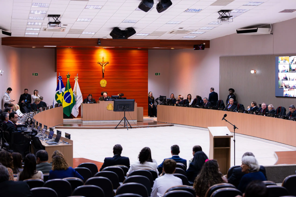 Desembargadores reunidos no plenário do Tribunal de Justiça de Mato Grosso durante sessão, com público assistindo